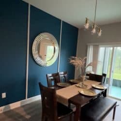Dining room with a freshly painted teal accent wall in a Worcester area home