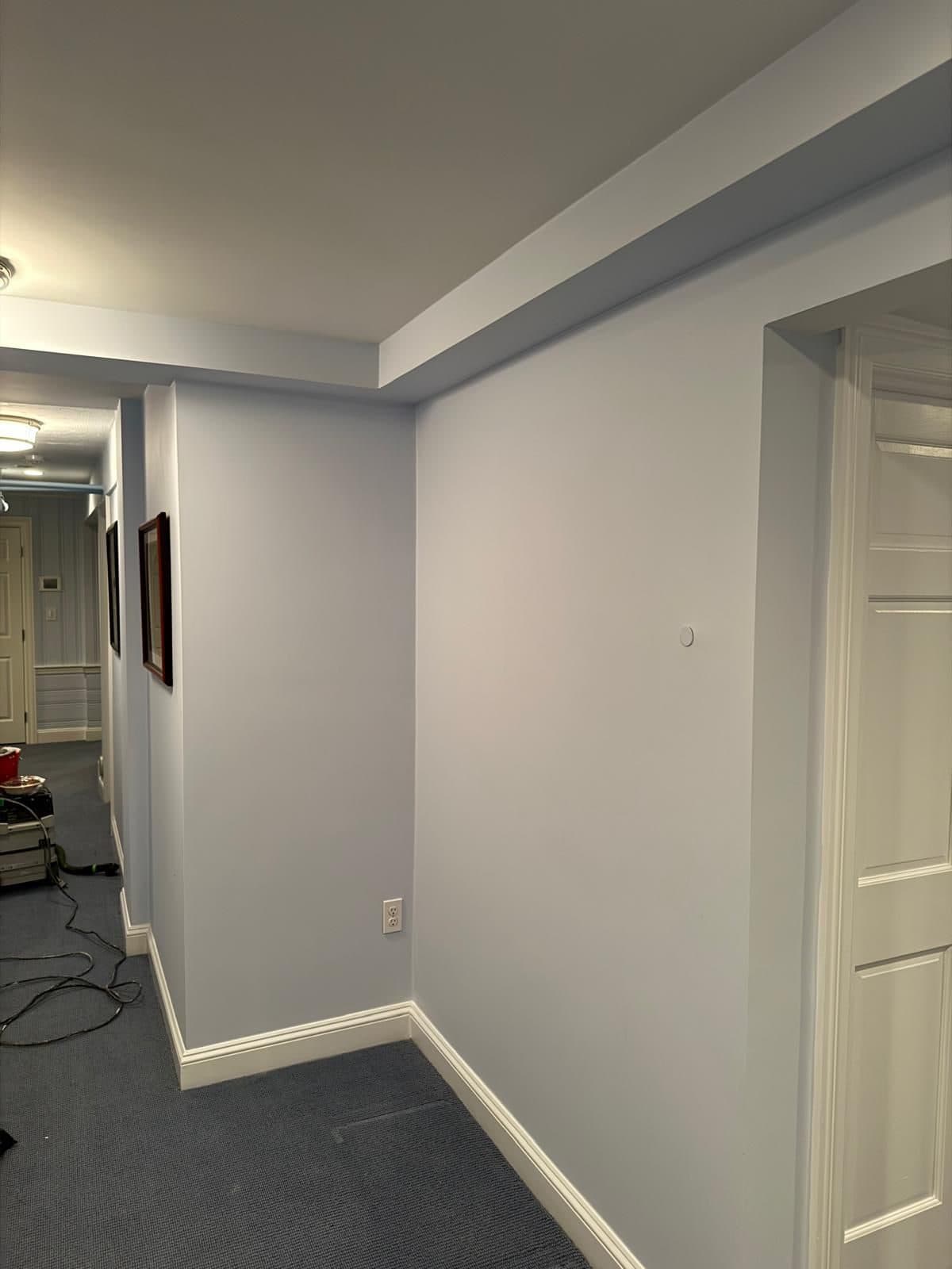 Freshly painted blue-gray hallway in a Worcester County home with clean trim and smooth walls